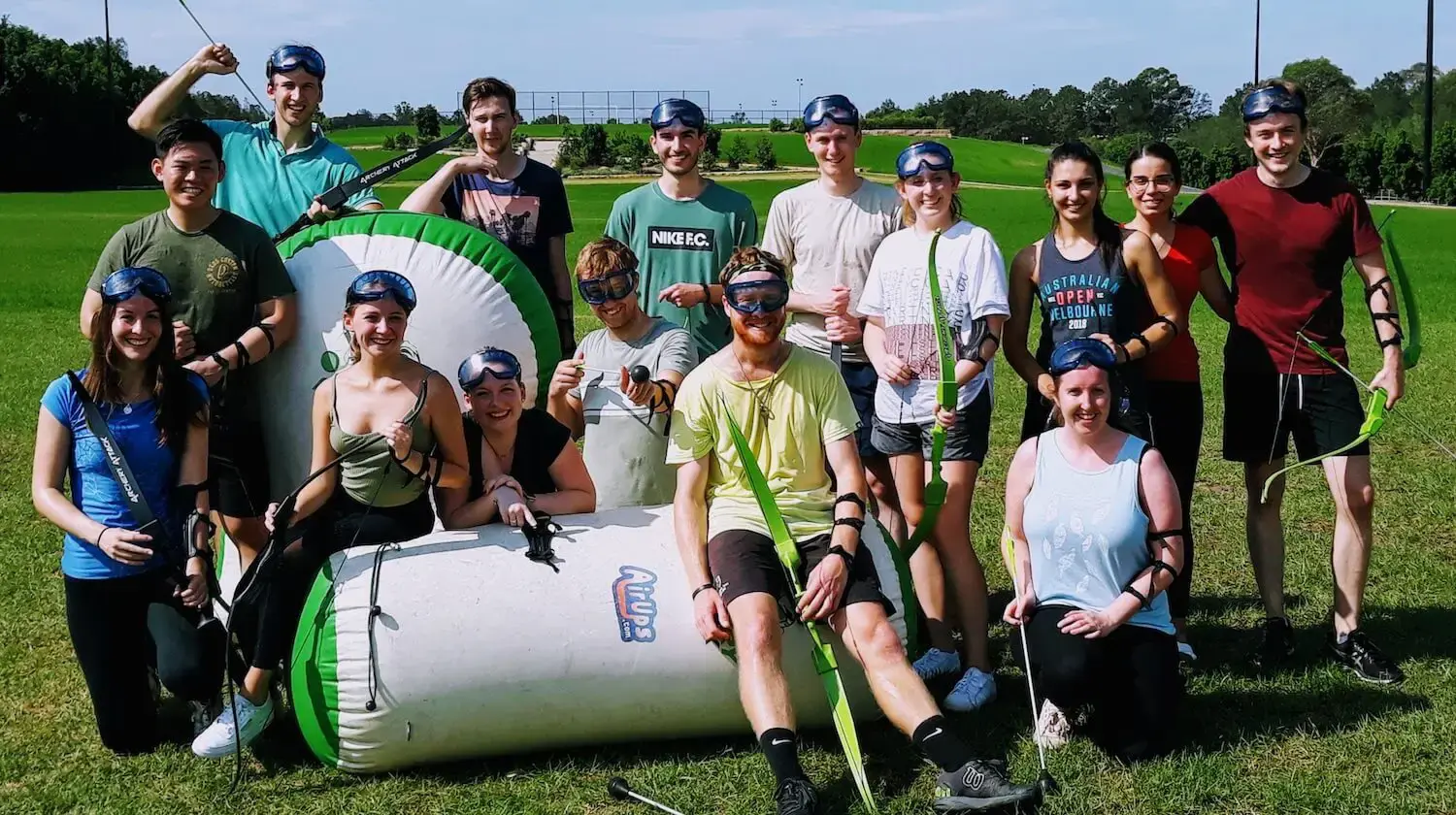 Corporate group celebrating together after an Battle Archery team building round.